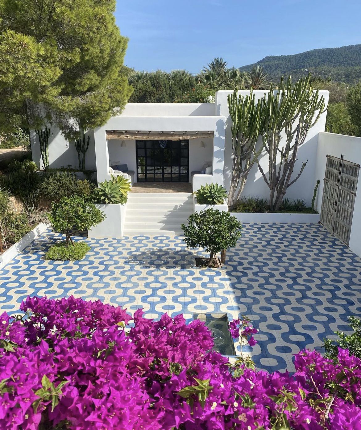 White Mediterranean villa with patterned tile courtyard